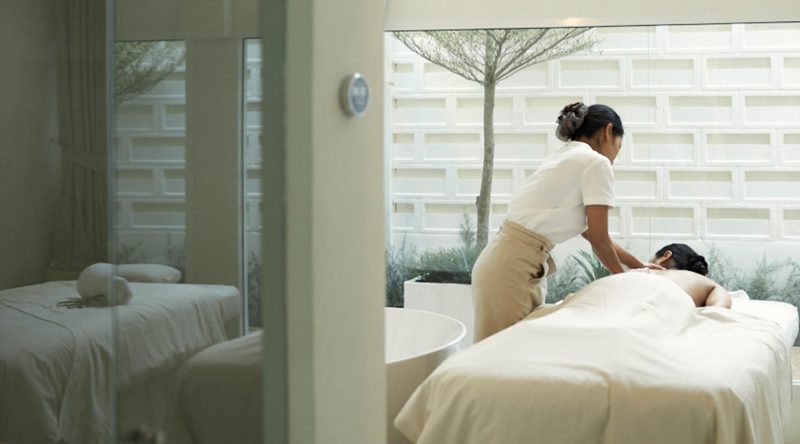 A skilled therapist giving a client a massage at White Wood Green luxury spa in Ekkamai