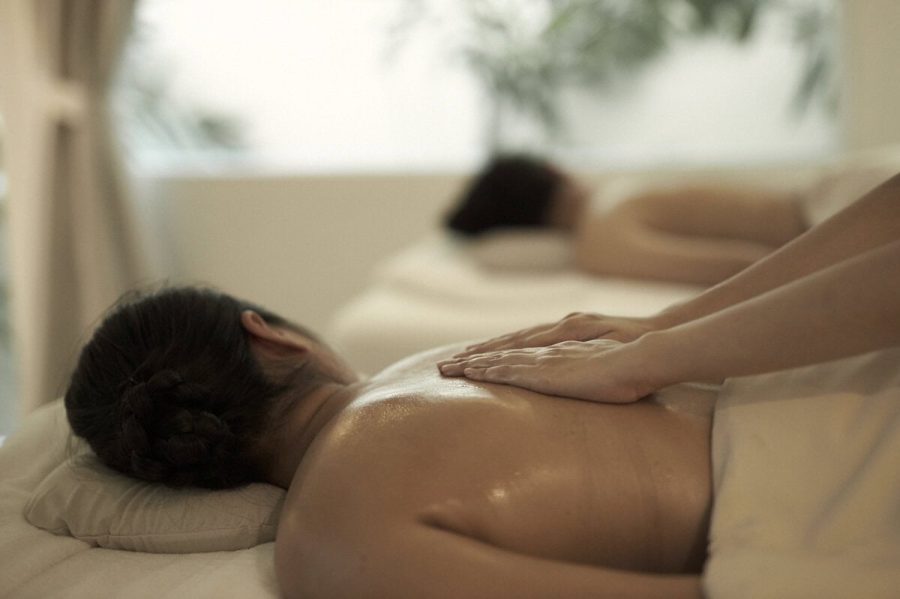 Young women receiving a Thai massage at a spa in Thailand. This can improve mental health.